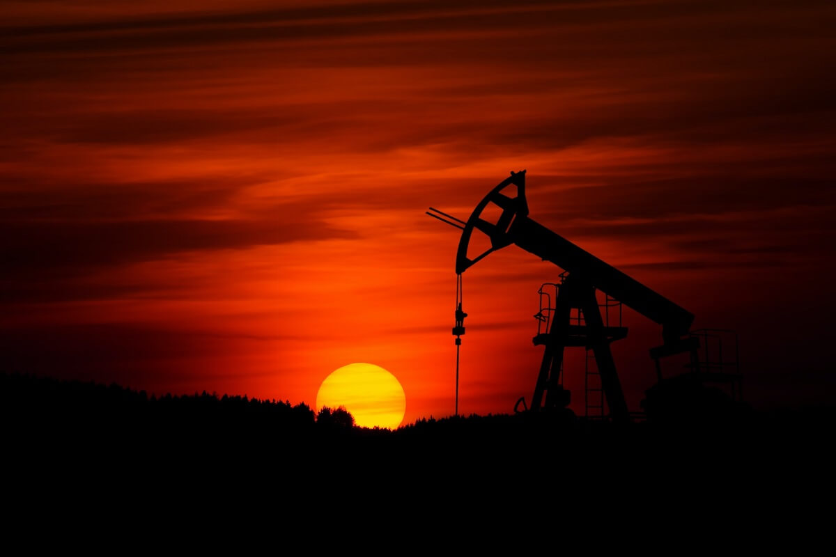 Oil pump jacks extracting crude oil at sunset